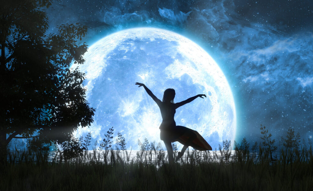 Silhouette dancing under a full moon.