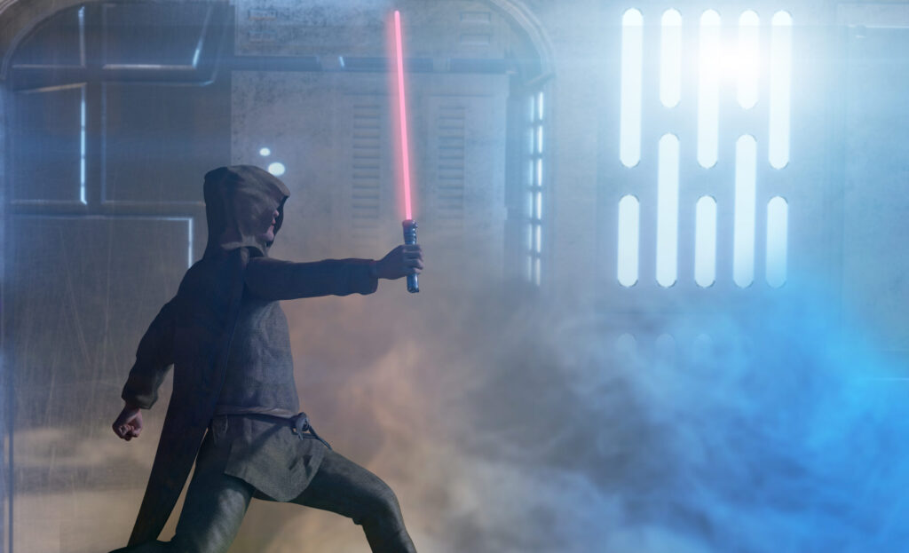 Person wielding a lightsaber in fog